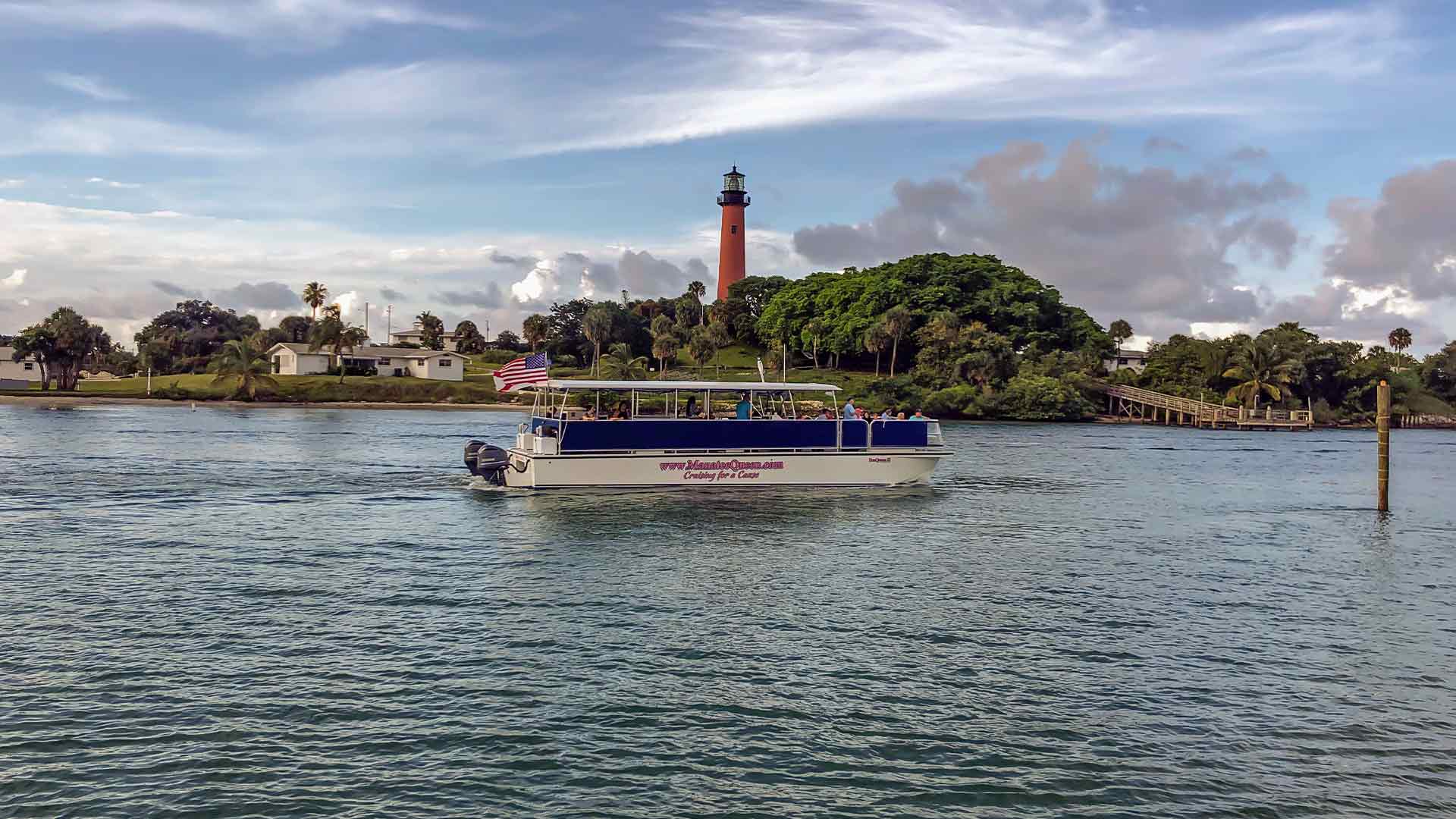 Manatee Queen cruising with Jupiter lighthouse in background